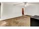 Simple living room with a ceiling fan, dated carpet and an opening into another room at 10159 Hodge Rd, Clayton, IN 46118