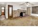 Modest living room featuring wood-look wall paneling, ceiling fan, and dated carpeting at 10159 Hodge Rd, Clayton, IN 46118