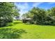 A large, green, grassy yard surrounding the home at 10159 Hodge Rd, Clayton, IN 46118