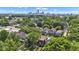 See the beauty of this aerial view showing a neighborhood with lush trees and a city skyline in the distance at 1105 Windsor St, Indianapolis, IN 46201