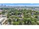 This scenic aerial view showcases a neighborhood near a city skyline, filled with lush green trees at 1105 Windsor St, Indianapolis, IN 46201