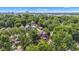 An aerial view of a vibrant neighborhood shows houses with trees and the city skyline in the background at 1105 Windsor St, Indianapolis, IN 46201