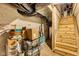 Basement stairs and storage area featuring wooden steps at 1105 Windsor St, Indianapolis, IN 46201
