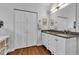 Bathroom boasts a dual vanity with granite countertops and white cabinets, complemented by wood floors at 1105 Windsor St, Indianapolis, IN 46201