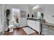 Elegant bathroom with dual sinks, granite countertops, and wood floors at 1105 Windsor St, Indianapolis, IN 46201