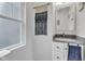 Well-lit bathroom featuring a granite countertop vanity and decorative macrame wall hanging at 1105 Windsor St, Indianapolis, IN 46201