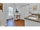 Bright bathroom featuring wood floors, white cabinets, granite counters, and a decorative cabinet for storage at 1105 Windsor St, Indianapolis, IN 46201