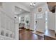 Warm entryway with hardwood floors, a front door with sidelights, and a glimpse of the cozy living room at 1105 Windsor St, Indianapolis, IN 46201