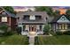 Beautiful two-story home with a front yard and charming front porch at sunset at 1105 Windsor St, Indianapolis, IN 46201