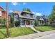 Classic two-story home with a charming front porch, red door, and well-maintained yard at 1105 Windsor St, Indianapolis, IN 46201