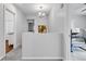 Open hallway showcasing modern chandelier lighting and neutral wall paint and carpet at 1105 Windsor St, Indianapolis, IN 46201