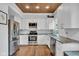 Modern kitchen with stainless steel appliances, white cabinets, and granite countertops at 1105 Windsor St, Indianapolis, IN 46201
