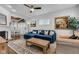 Spacious living room with a fireplace, blue sectional sofa, and adjacent dining area at 1105 Windsor St, Indianapolis, IN 46201