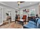 Open-concept living room with hardwood floors, a sofa, and a separate sitting area at 1105 Windsor St, Indianapolis, IN 46201