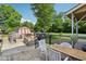 Spacious backyard with a stone patio, shed, outdoor dining furniture, and grassy area at 1129 Trowbridge St, Indianapolis, IN 46203