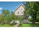 Charming two-story home with a front porch and mature trees in a well-maintained yard at 1129 Trowbridge St, Indianapolis, IN 46203