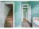 Hallway with teal walls, stairs to the left, bedroom in front and right at 1129 Trowbridge St, Indianapolis, IN 46203