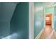 Hallway leading to a bedroom, features a view of the bedroom and ample lighting at 1129 Trowbridge St, Indianapolis, IN 46203