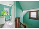 Hallway with teal walls, leading to stairs and another room with window at 1129 Trowbridge St, Indianapolis, IN 46203