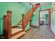 A staircase with wood railing and trim leads to the upper level of the home at 1129 Trowbridge St, Indianapolis, IN 46203