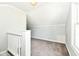 Attic features neutral carpet, slanted ceilings, and staircase at 114 South St, Southport, IN 46227