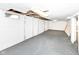 Open basement area featuring painted concrete walls and floor, exposed ceiling, and natural light from a window at 114 South St, Southport, IN 46227