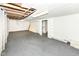 Spacious unfinished basement with painted walls and floor, exposed ceiling, and doorway at 114 South St, Southport, IN 46227