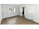 Bedroom with blue walls, wood look flooring, natural light from windows, and closet at 114 South St, Southport, IN 46227