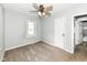 Cozy bedroom with a ceiling fan, plush carpet, and easy access to the bathroom at 114 South St, Southport, IN 46227