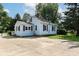 Light blue home with red shutters, nice lawn and long driveway at 114 South St, Southport, IN 46227