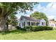 Traditional light blue home with a well-maintained lawn and mature trees at 114 South St, Southport, IN 46227
