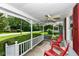 Comfortable front porch with ceiling fan and decorative white railing at 114 South St, Southport, IN 46227