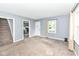 Living room with stairs and door to kitchen at 114 South St, Southport, IN 46227