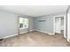 Neutral living room with natural light from the large window at 114 South St, Southport, IN 46227