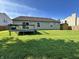 Expansive backyard with a wooden deck, privacy fence, and mature trees, creating a serene outdoor space at 1202 Tomahawk Pl, Martinsville, IN 46151