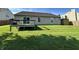 Spacious backyard featuring a deck, green grass, wood fence and shed at 1202 Tomahawk Pl, Martinsville, IN 46151