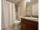 Bathroom featuring a shower with a curtain, toilet, sink, mirror, and wooden cabinet at 1202 Tomahawk Pl, Martinsville, IN 46151