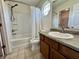 Clean bathroom with a bathtub, shower, and a single sink vanity with wood cabinets at 1202 Tomahawk Pl, Martinsville, IN 46151