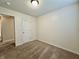 Cozy bedroom with neutral carpet, white walls, and a door at 1202 Tomahawk Pl, Martinsville, IN 46151