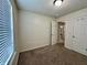 Well-lit bedroom with cozy carpet and a view to the laundry room at 1202 Tomahawk Pl, Martinsville, IN 46151