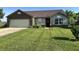 Charming single Gathering home with a brick accent, attached garage, manicured lawn and landscaped front yard at 1202 Tomahawk Pl, Martinsville, IN 46151