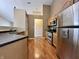 Functional kitchen features stainless steel appliances, wooden cabinets and hardwood floors at 1202 Tomahawk Pl, Martinsville, IN 46151