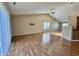 Sunlit living room featuring high ceilings, wood laminate flooring, and sliding glass doors at 1202 Tomahawk Pl, Martinsville, IN 46151