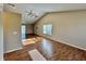 Bright living room with vaulted ceiling, wood floors, and large windows for plenty of natural light at 1202 Tomahawk Pl, Martinsville, IN 46151