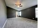 Large main bedroom with a ceiling fan, carpet, and ensuite bath, offering a private retreat at 1202 Tomahawk Pl, Martinsville, IN 46151