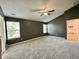 Spacious carpeted main bedroom with natural light, a ceiling fan, and ensuite bathroom access at 1202 Tomahawk Pl, Martinsville, IN 46151