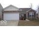Charming single-story home featuring a brick facade, attached garage, and well-maintained lawn at 12451 Cricket Song Ln, Noblesville, IN 46060