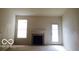 Bright living room featuring a modern fireplace and a sliding glass door for natural light at 12451 Cricket Song Ln, Noblesville, IN 46060