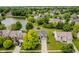 Aerial shot of home with lush greenery, mature trees, and a neighborhood lake for scenic outdoor living at 12490 Windbush Way, Carmel, IN 46033
