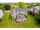 Aerial shot of back of house featuring deck, outdoor space and a well-manicured lawn for outdoor living at 12490 Windbush Way, Carmel, IN 46033